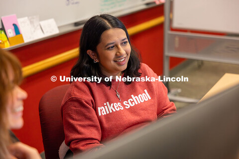 Radhika Damle shows Katia Henrriquez something on her screen as they work on their Raikes School Des