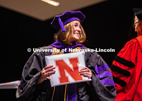 Abigail Bennetts smiles at her family members in the crowd after receiving her diploma and hood. 202