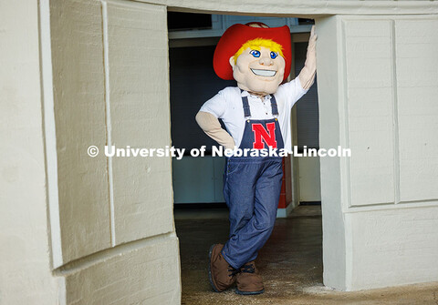 Brady Moylan as Herbie leans against a column in Memorial Stadium. Moylan has been Herbie for the la
