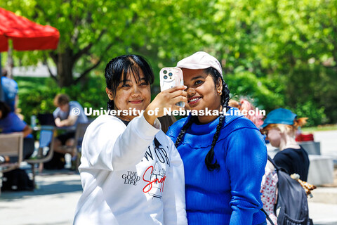 Graduate students (left) Anisha Khandokar and Bhavana Sreekumar take a selfie after getting their ha