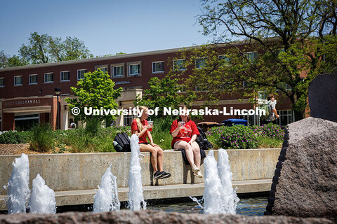 (Left) Senior, Hannah Kress, and Sophomore, Ellie Hoegemeyer, sit by the Broyhill Fountain drinking 