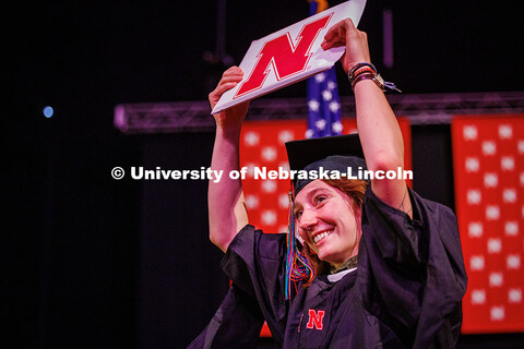 Educational Administration Graduate student, Mandi Laib, holds her diploma up in the air after recei