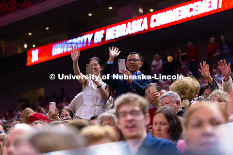 Family members cheer and record video of their student in Pinnacle Bank Arena during the processiona