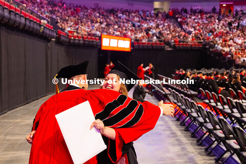 Kenneth Pyle gives a hug to graduate Clara Walstad, who was one of his advisees in the Fisheries and