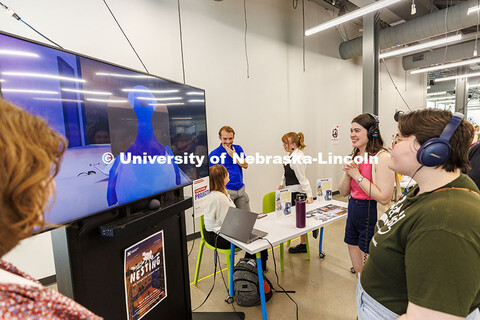 Juliah Fort (Green shirt left) and Lillie Rademacher watch and listen to a project called “Nesting