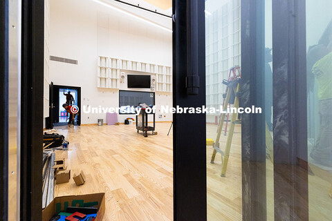 Contractors install sliding doors on soundproofed private recording booths in the new Hixson-Lied Co