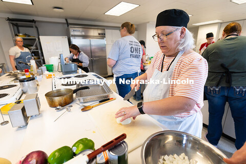Elaine Rouse, kitchen manager for St. Margaret Mary School in Omaha, dices an onion that will be use