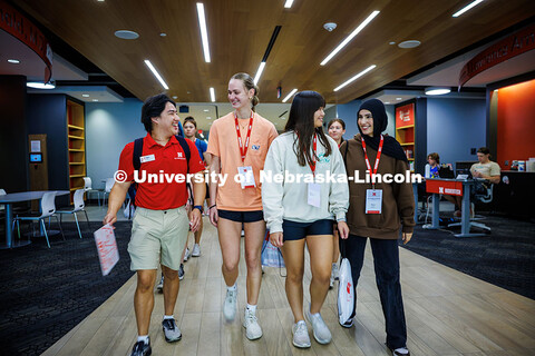 Gideon Casimiro (left), a junior political science major and NSE Leader, directs the incoming Husker
