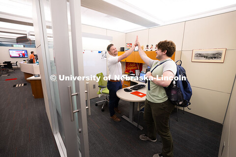 Adam Christiansen, Academic Navigator in the Explore Center, gives a high five to Jacob Behnk, a sen