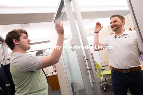 Adam Christiansen, Academic Navigator in the Explore Center, gives a high five to Jacob Behnk, a sen