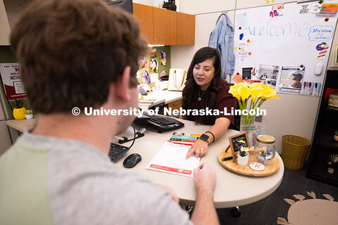 Selma De Anda Gallegos shares information about the Explore Center with Jacob Behnk, a senior studyi