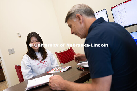 Dave Nebel speaks with Mireu Ryu, a senior studying computer science, in his office in Hawks Hall. N