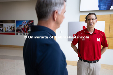 Dave Nebel (left) and Parker Reed chat in the lobby of Hawks Hall, where they both work in the Busin