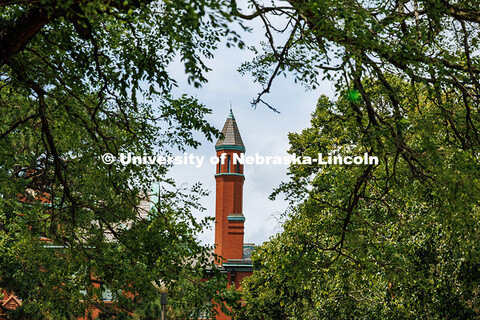 Architecture Hall's turret is framed by trees. Summer on City Campus. July 16, 2025. 