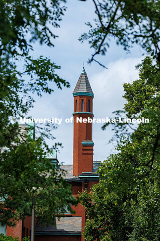 Architecture Hall's turret is framed by trees. Summer on City Campus. July 16, 2025. 