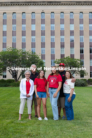 Sisters Madison and Lauren Haring pose with their family in front of Love Library. The Haring family