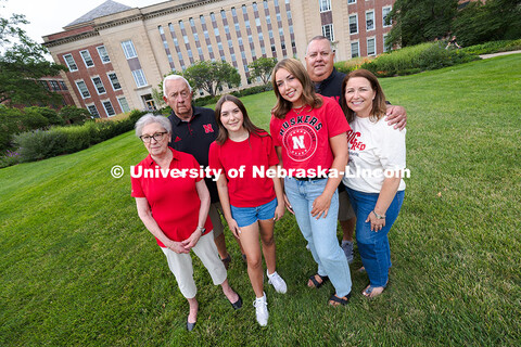 Sisters Madison and Lauren Haring pose with their family in front of Love Library. The Haring family