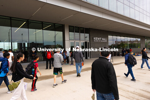 Competitors, coaches and volunteers walk into Kiewit Hall on the University of Nebraska–Lincoln ca