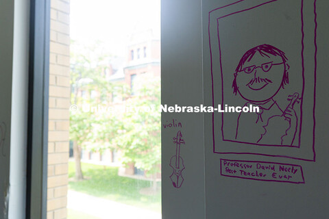 A student rendering of David Neely, Professor of Violin, drawn on the wall of his office in the old 