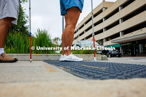 Lori Maestas stands on tactile paving, a textured surface that helps pedestrians with visual impairm