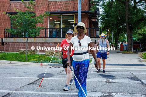 Sharon Cherono orientates through a crosswalk using her long cane during the mobility and orientatio