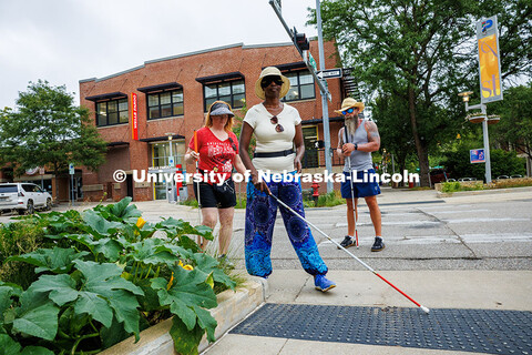 Sharon Cherono navigates around landscaping in downtown Lincoln using her long cane during an orient