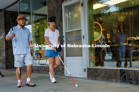 Lori Maestas, a teacher for the visually impaired, uses her guide cane to navigate downtown Lincoln 