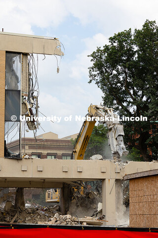 A concrete pulverizer attachment is used on an excavator to break apart the former Westbrook Music B