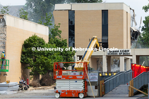 Pieces of the Westbrook Music Building are knocked down during demolition as workers remove the bric