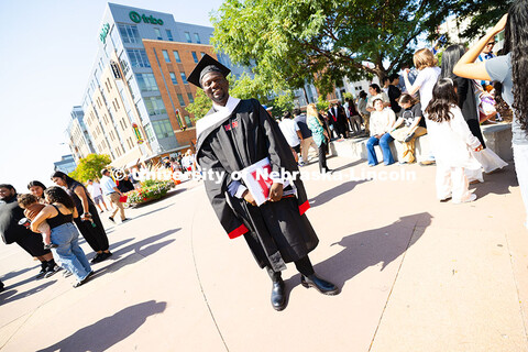 Oluseye Fakinlede poses for a photo in the Haymarket after the summer commencement ceremony. Summer 