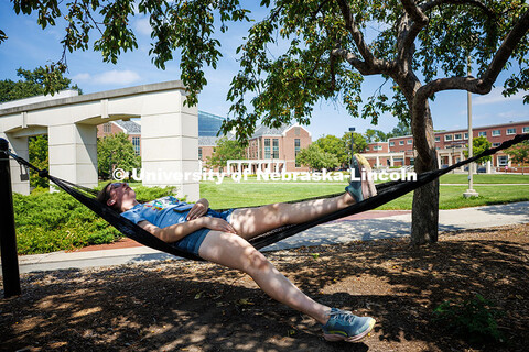 Staff member Claire Richardson lounges in the shade on a hammock in the Nebraska Union Plaza. August