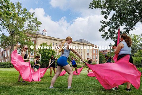 Madeline Woods practices the Cornhusker Marching Band’s Color Guard routine in front of Love Libra
