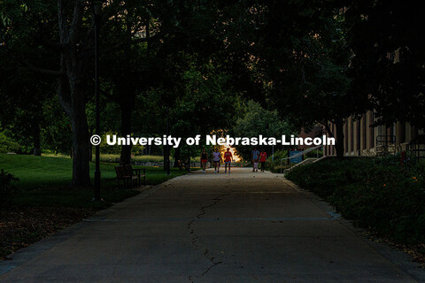 Students crossing campus as the sun sets on City Campus in the summer. August 21, 2025. 