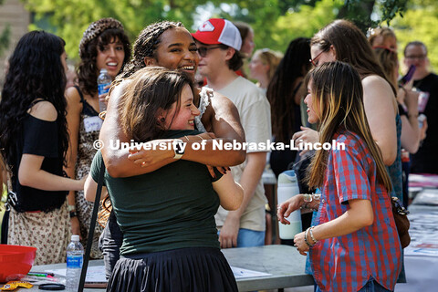 Ren DeFor and Sydney Kwasa (front to back) hug at the Fine and Performing Arts Big Red Welcome picni