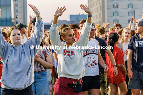 UNL students raise their hands in response to the DJ announcing different cues during Playfair. More