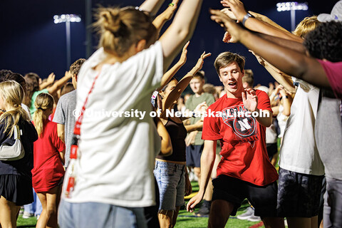 A student dances through a line following instructions by the DJ at Playfair. More than a thousand s
