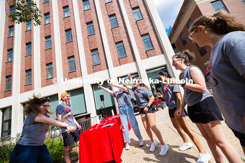 Student Ambassadors jam to music outside of Oldfather Hall during the College of Arts and Sciences w