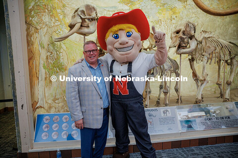 Vice Chancellor of Business and Finance, Mike Zeleny, poses for a photo with Herbie Husker during hi