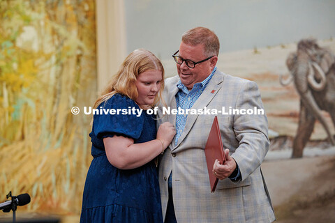 Mike Zeleny hugs his daughter who presented him with his Emeritus certificate during his farewell re