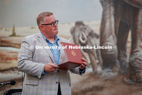 Mike Zeleny holds his Emeritus Certificate during his farewell reception in Morrill Hall. August 21,
