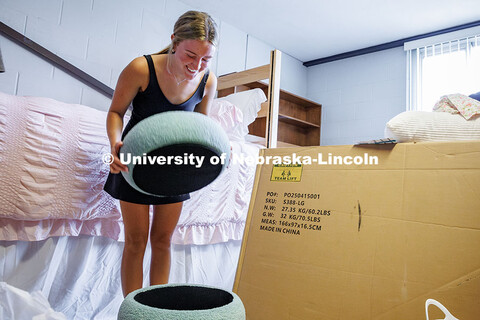 Addison Empfield opens up her stool in Abel Hall as she sets up her dorm. Residence hall move-in. Au