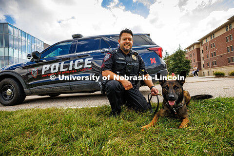 Anderson Delgado, a Police Sergeant and Explosive Detective Canine Handler for UNLPD, poses in front