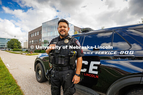 Anderson Delgado, a Police Sergeant and Explosive Detective Canine Handler for UNLPD, poses in front