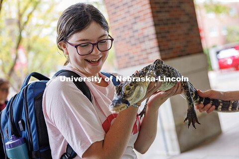 Maddy Mellon, freshman journalism major, holds Tripod the alligator during the Wildlife Encounters P