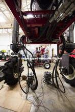 Santosh Pitla discusses the electronics on a robotic cart with Tyler Troyer, graduate student in BSE