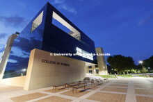 A person enters the College of Business' new Howard L. Hawks Hall early morning on the first day of 