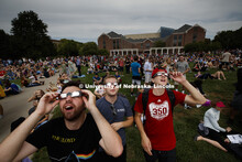 Sophomores Rob Hammack, Kevin Heckman and Mason Roe gazed up at 12:49 pm. Students gather on the gre
