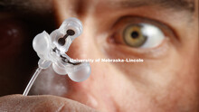 Stephen Morin, Assistant Professor of Chemistry, holds soft robotic parts produced by his lab. Decem