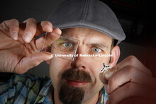 Stephen Morin, Assistant Professor of Chemistry, holds soft robotic parts produced by his lab. Decem