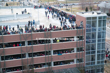 Spectators watch from the roof of the Abel Sandoz parking garage northeast of the Cather Pound Resid